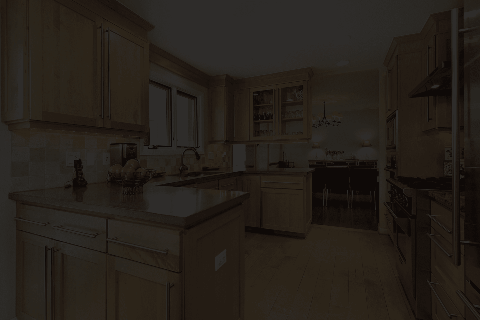 Light wood kitchen cabinets with granite countertops, warm flooring, ample storage, and a bright, inviting layout.
