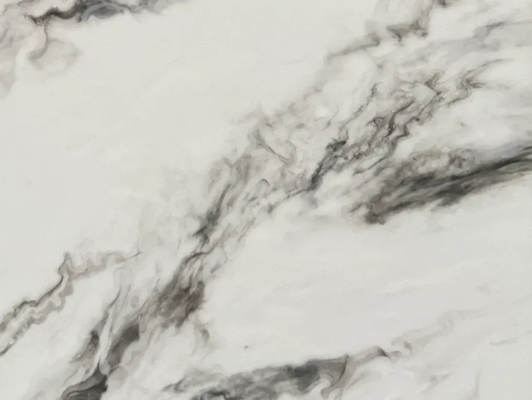 White marble texture with gray and black veining, creating an elegant and natural pattern. The design conveys a sense of luxury and sophistication.