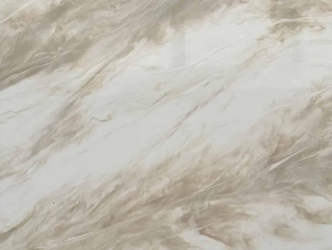 Smooth, polished marble surface with soft beige and cream swirls creating a natural, calming pattern. The texture is sleek and elegant.